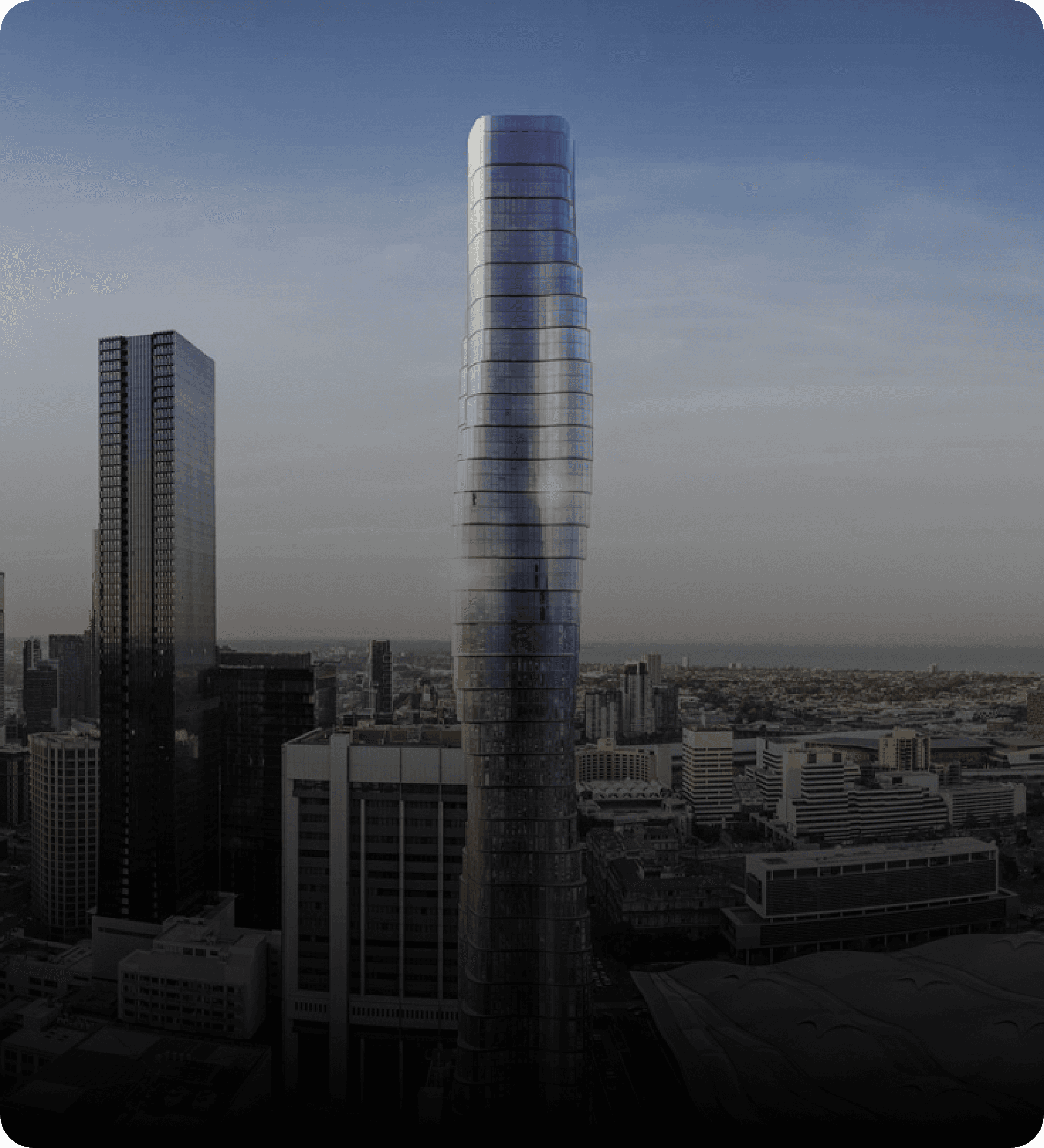 High-rise residential tower against a city skyline at dusk — context image for Carell's joinery and installation projects